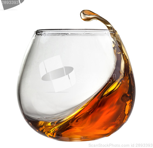 Image of Splash of cognac in glass isolated on white