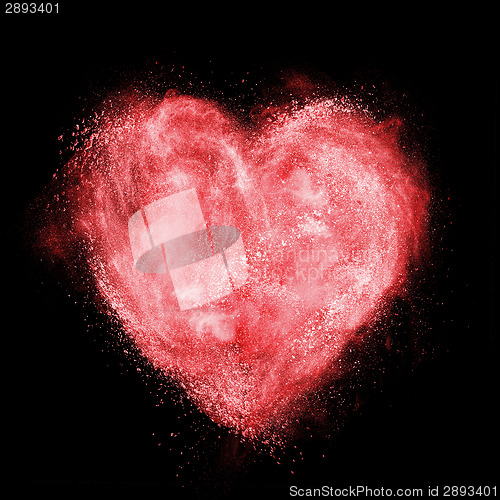 Image of red heart made of white powder explosion isolated on black