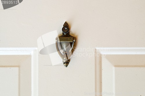 Image of brass door knocker with peep hole