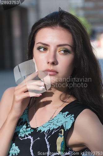Image of Attractive young woman in dress
