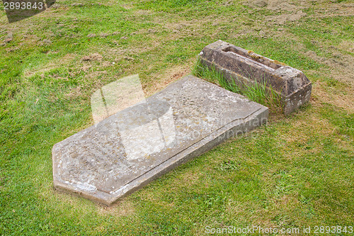 Image of Very old broken gravestone in the cemetery