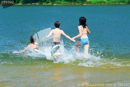 Image of Children running into water