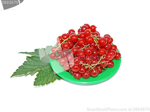 Image of Red currant on small plates decorated with leaves isolated