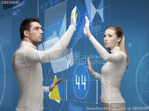 Image of man and woman working with virtual screen