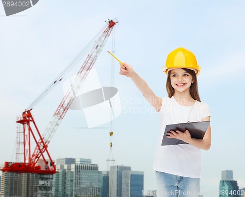 Image of smiling little girl in hardhat with clipboard