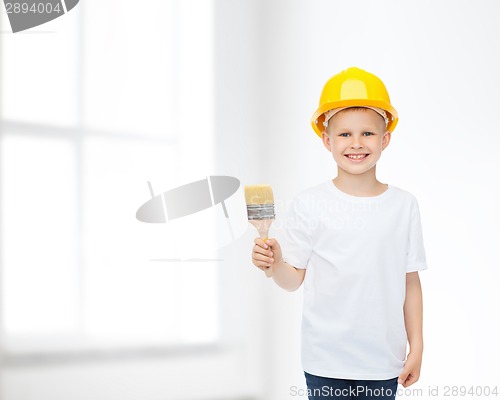 Image of smiling little boy in helmet with paint brush