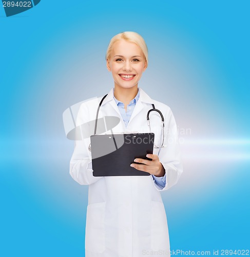 Image of smiling female doctor with clipboard