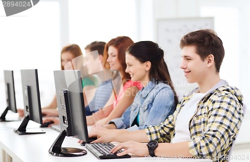 Image of male student with classmates in computer class