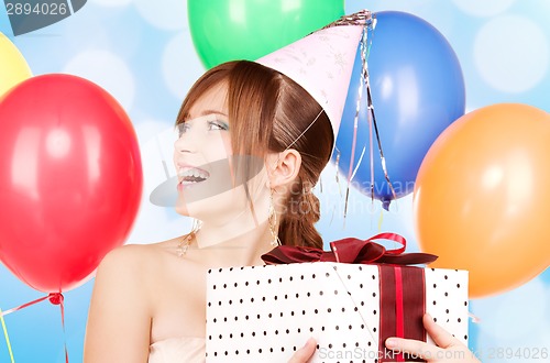 Image of party girl with balloons and gift box