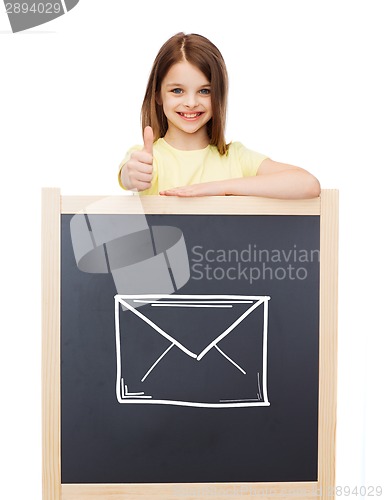 Image of smiling girl with blackboard showing thumbs up