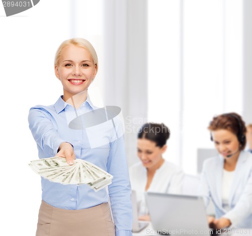 Image of young businesswoman with dollar cash money