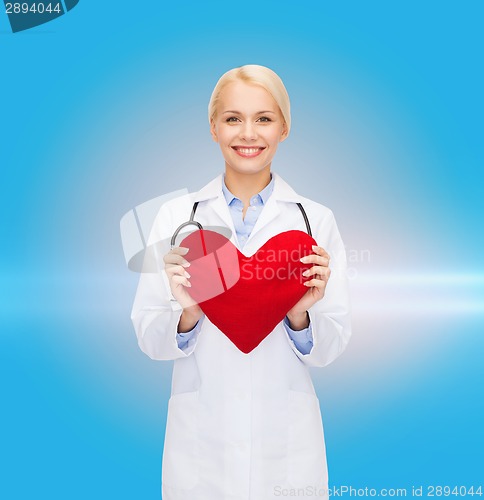 Image of smiling female doctor with heart and stethoscope