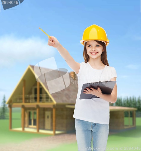 Image of smiling little girl in hardhat with clipboard