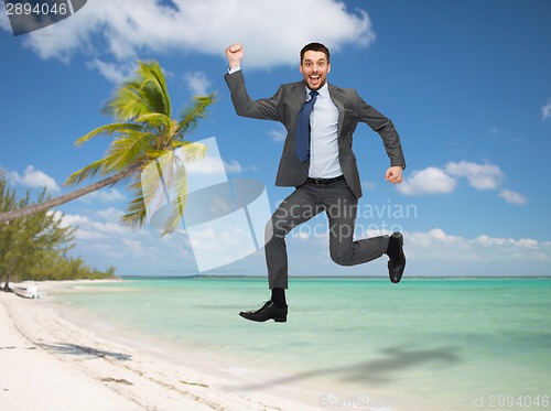 Image of smiling happy businessman jumping