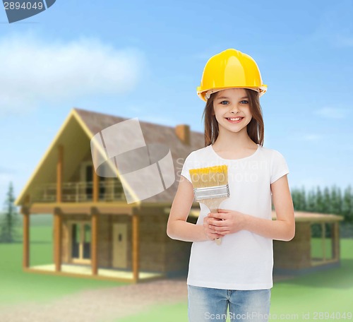 Image of smiling little girl in helmet with paint brush