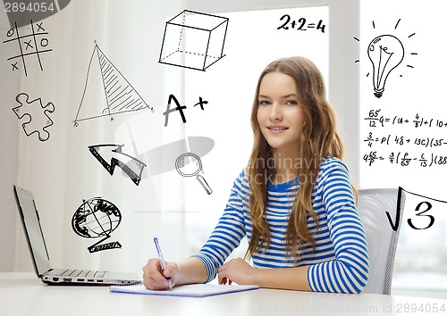 Image of smiling teenage girl laptop computer and notebook