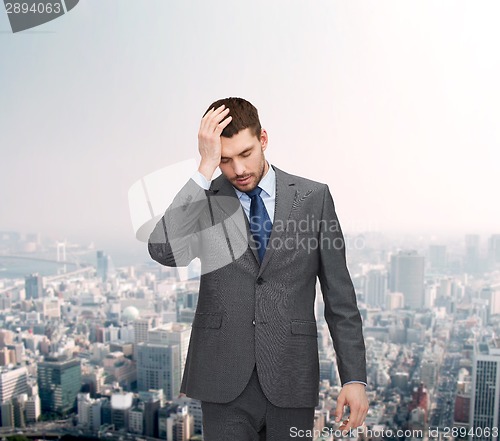 Image of handsome businessman having headache