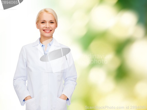 Image of smiling female doctor over natural background