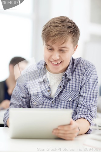 Image of smiling teenage student with tablet pc computer