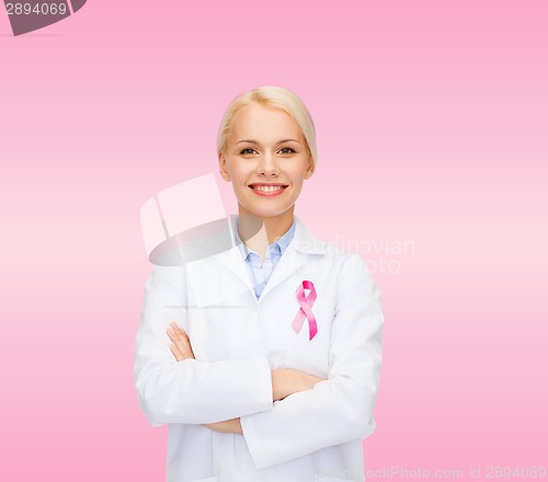 Image of smiling female doctor with cancer awareness ribbon