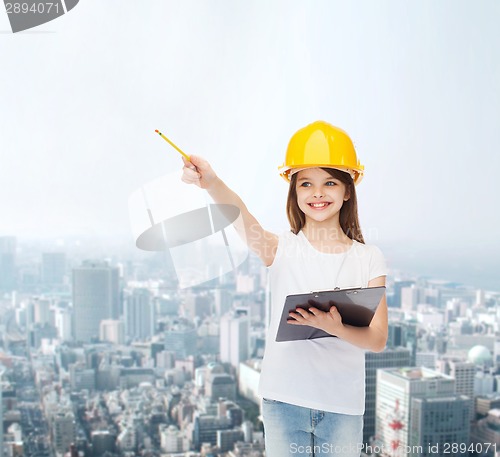 Image of smiling little girl in hardhat with clipboard