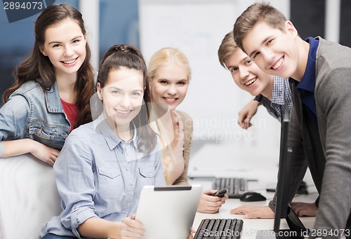 Image of students with computer monitor and tablet pc