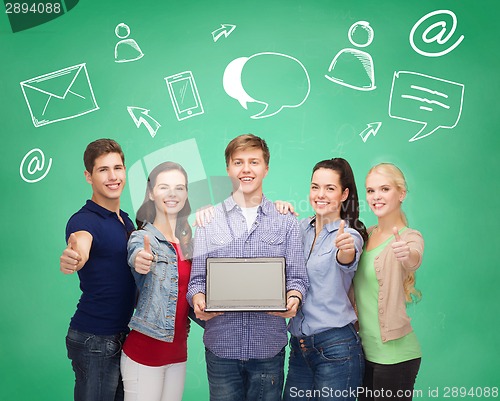 Image of smiling students with laptop showing thumbs up