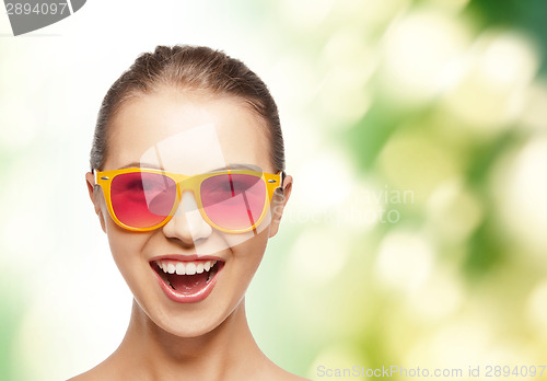 Image of happy teenage girl in pink sunglasses