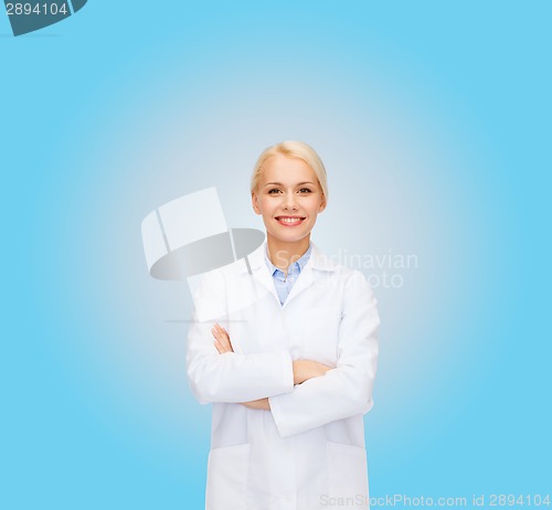 Image of smiling female doctor over blue background