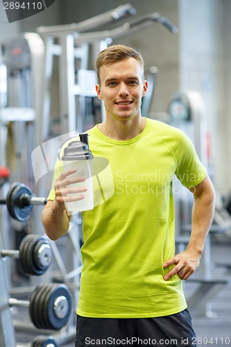 Image of smiling man with protein shake bottle
