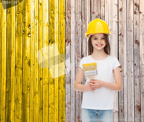 Image of smiling little girl in helmet with paint brush