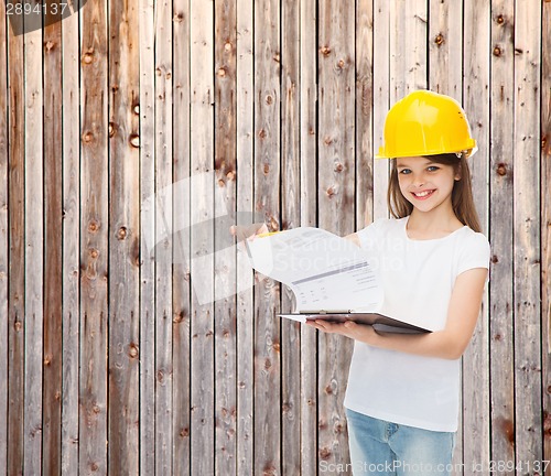 Image of smiling little girl in hardhat with clipboard