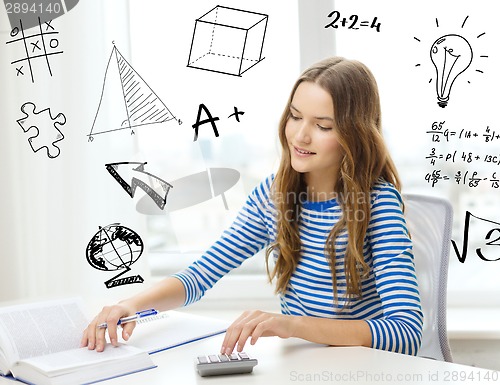 Image of student girl with book, notebook and calculator