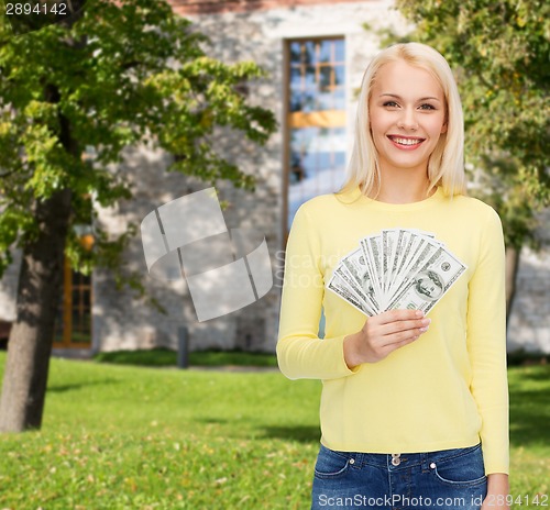 Image of smiling girl with dollar cash money