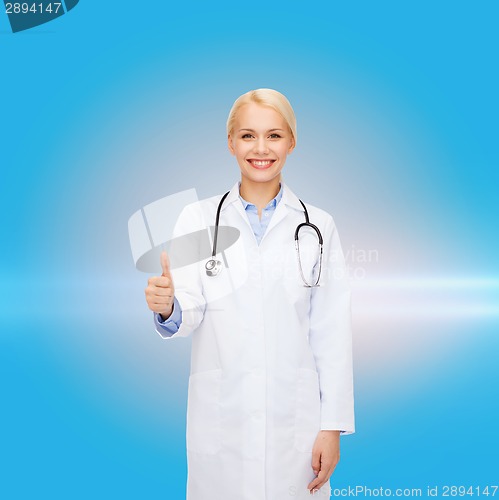 Image of smiling female doctor showing thumbs up