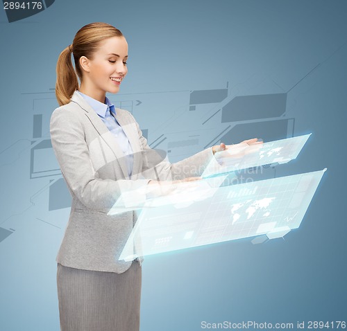 Image of smiling businesswoman working with virtual screens