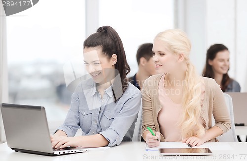 Image of students with laptop, tablet pc and notebooks