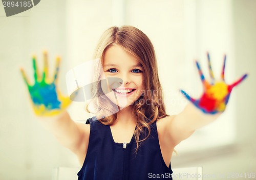 Image of girl showing painted hands