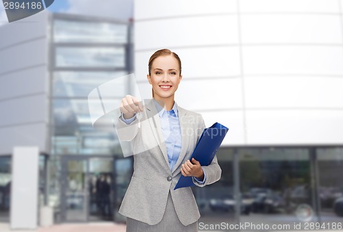 Image of smiling businesswoman with folder and keys