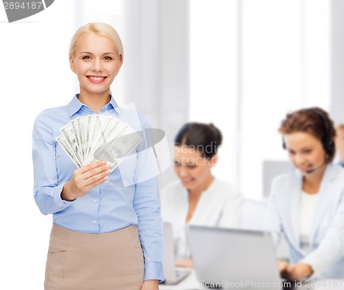 Image of young businesswoman with dollar cash money