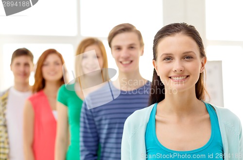 Image of smiling students with teenage girl in front