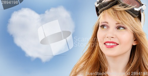 Image of smiling teenage girl in snowboard goggles