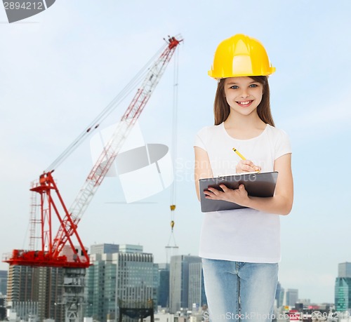 Image of smiling little girl in hardhat with clipboard