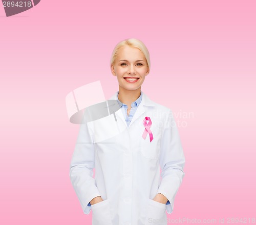 Image of smiling female doctor with cancer awareness ribbon