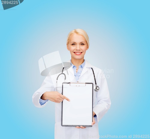 Image of smiling female doctor with clipboard