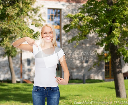 Image of smiling young woman in blank white t-shirt