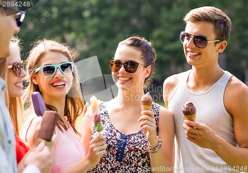 Image of group of smiling friends with ice cream outdoors