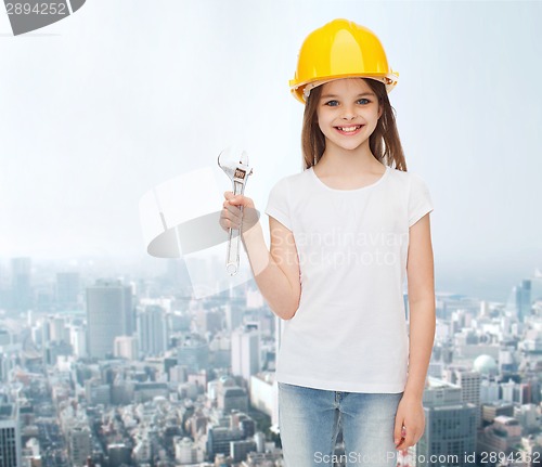 Image of smiling little girl in hardhat with wrench