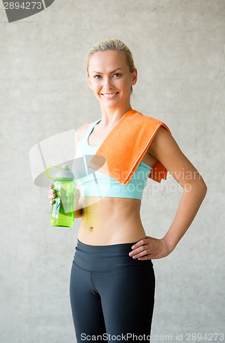 Image of woman with bottle of water in gym