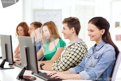 Image of female student with classmates in computer class